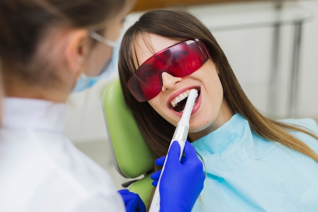 Woman getting procedure at dentist