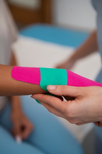 Woman getting support for her wrist in a rehabilitation center