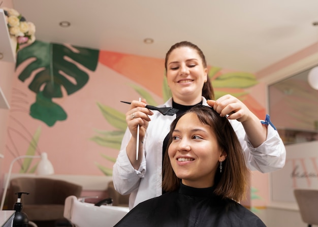 Woman getting treatment at hairdresser shop