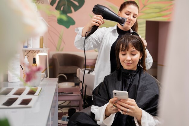 Woman getting treatment at hairdresser shop