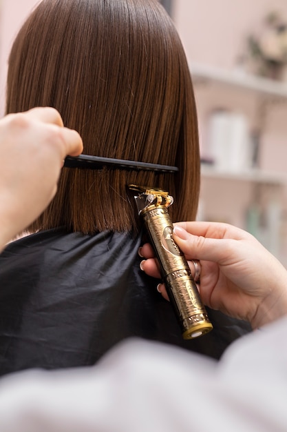 Woman getting treatment at hairdresser shop