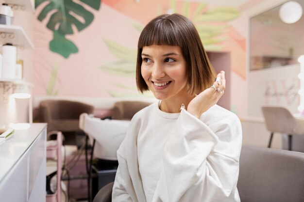 Woman getting treatment at hairdresser shop