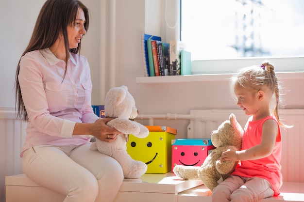 Woman and girl holding fluffy bears