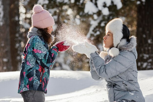 Woman and girl playing together medium shot