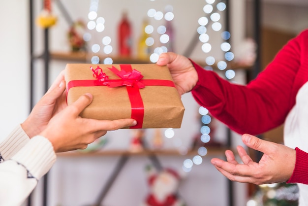 Free photo woman giving gift to boy