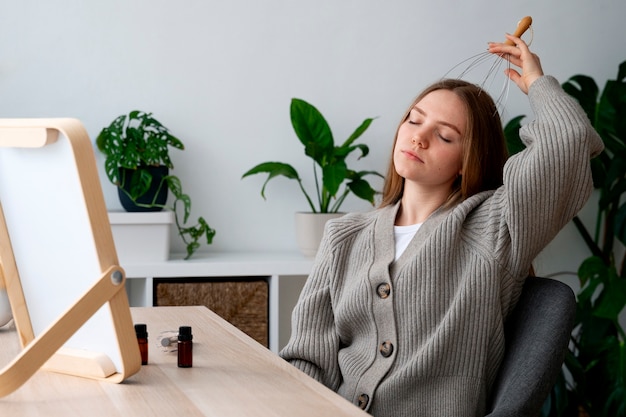 Free photo woman giving herself scalp massage