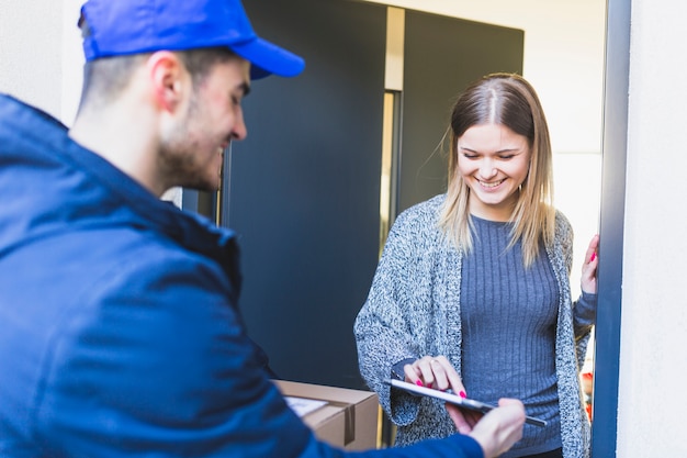 Woman giving online signature for delivery