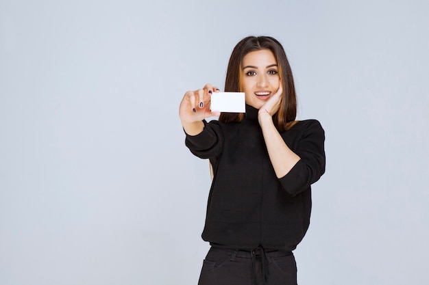 woman giving or receiving a business card and looks surprized. 