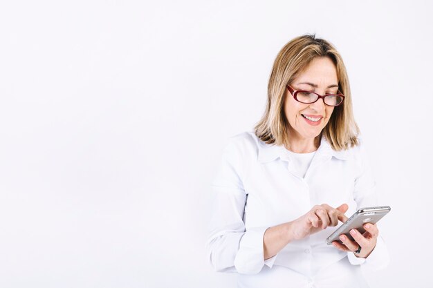 Woman in glasses using smartphone