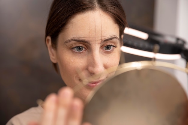 Free Photo woman going through a microblading procedure