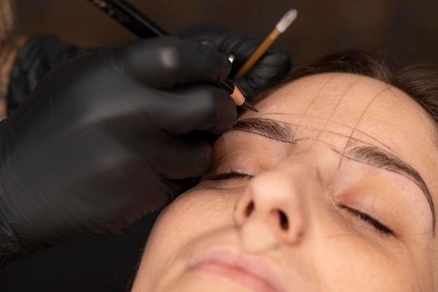 Free photo woman going through a microblading treatment