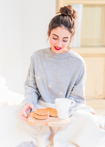 Woman in grey sitting with cookies 