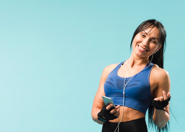 Woman in gym outfit enjoying music in headphones