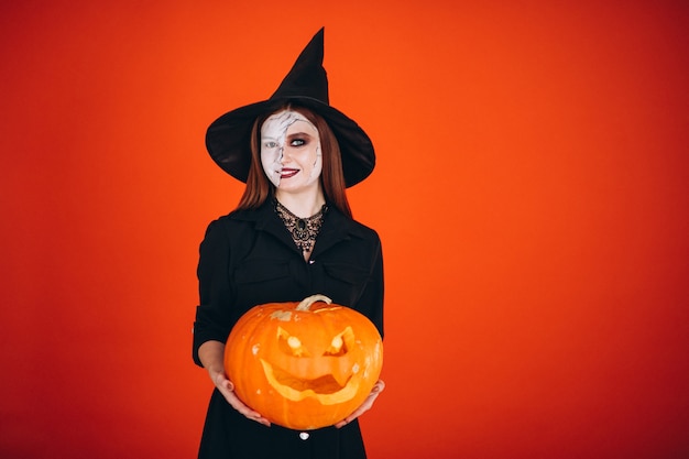 Woman in a halloween costume with a pumpkin 