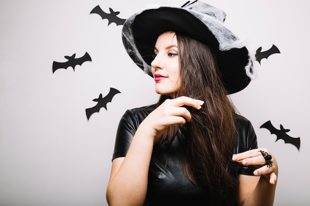 Free Photo woman in halloween hat playing with hair