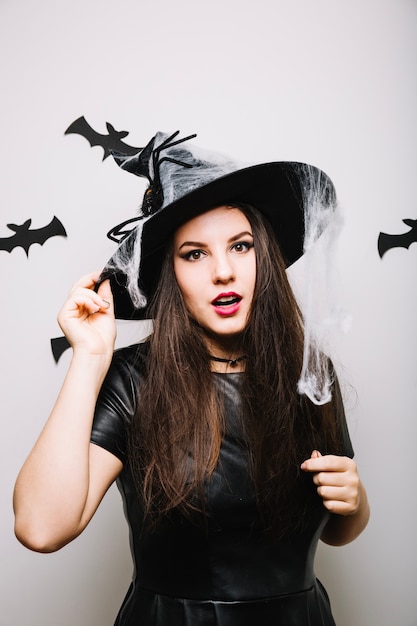 Free Photo woman in halloween hat in studio