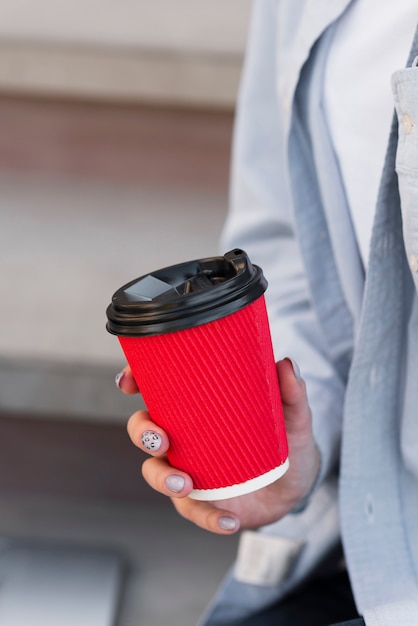 Woman hand holding a cup of coffee