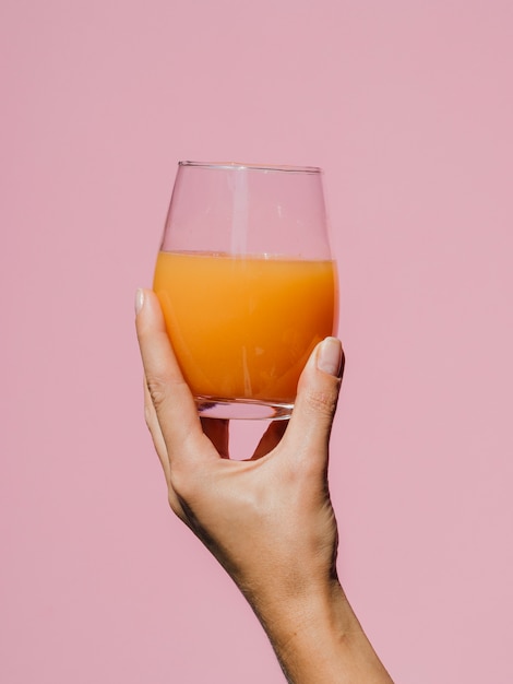 Woman hand holding a flavorful glass of juice 