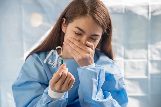 woman hand holding a pills take medicine according to the doctor's order