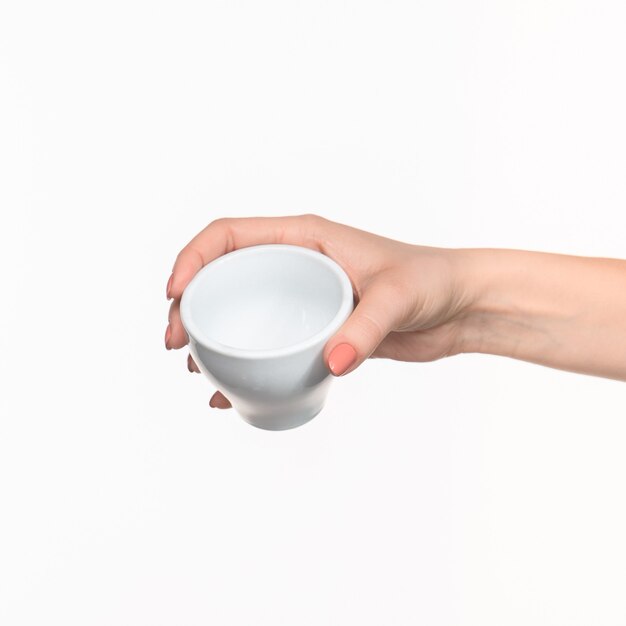 Woman hand with cup on white background