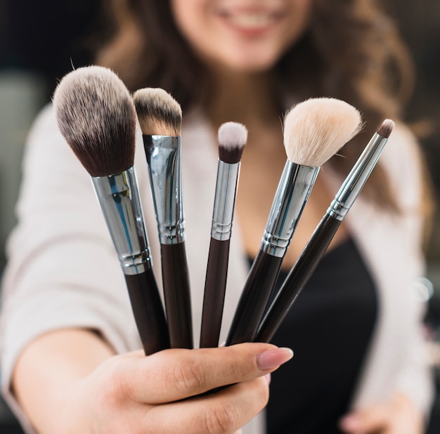 Woman hand with different brushes