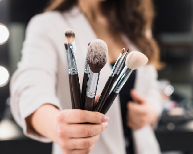 Woman hand with makeup brushes