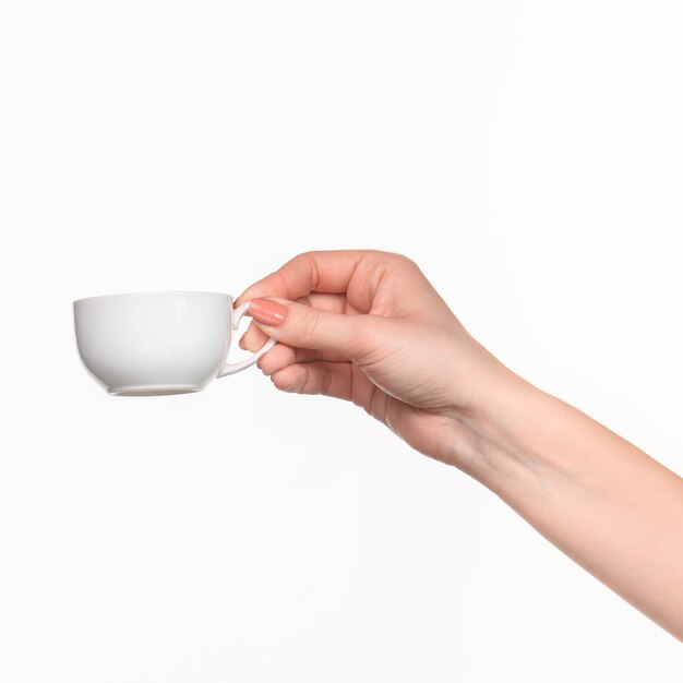 Woman hand with perfect white cup on white background