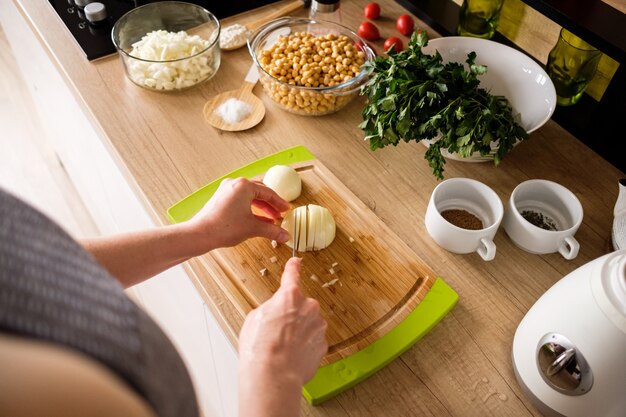 Woman hands, cutting onions