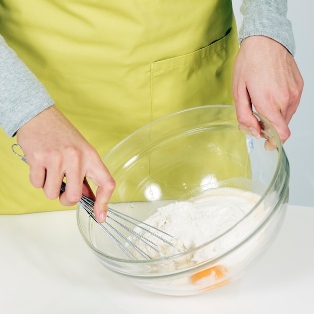 Free Photo woman hands whisking batter in kitchen