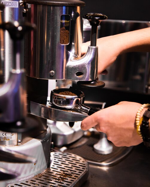 woman hands works with coffee mashine