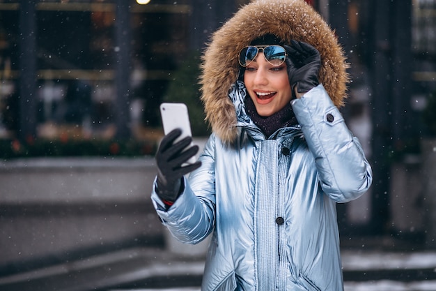 Free Photo woman happy in blue jacket talking on the phone