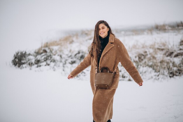 Woman happy in coat in winter outside in park