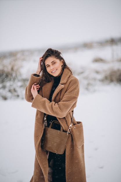 Free photo woman happy in coat in winter outside in park