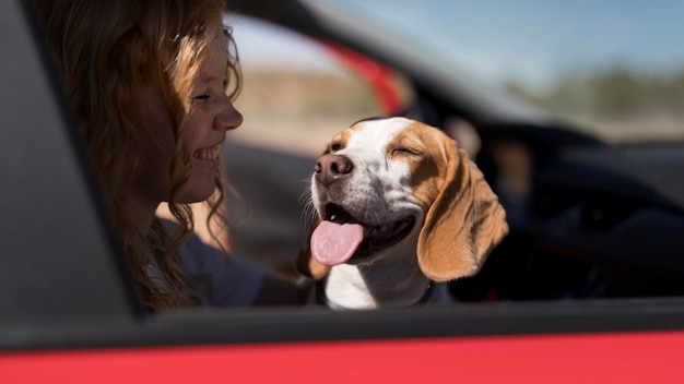 Woman and happy dog going on a ride