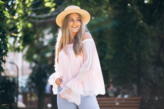 Woman happy in hat outside the street