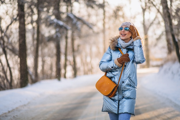 Woman happy walking in a winter park