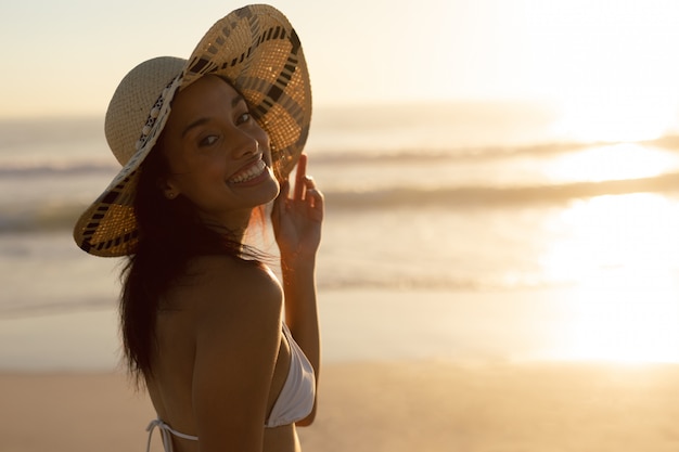 Woman in hat standing on the beach