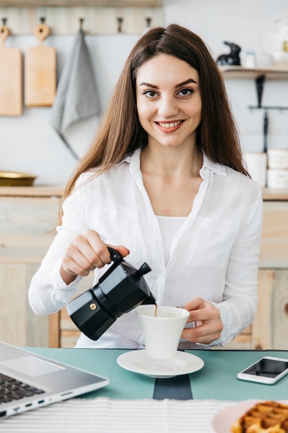 Woman having breakfast at the kitchen