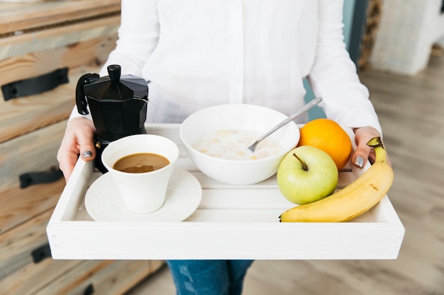 Woman having breakfast at the kitchen