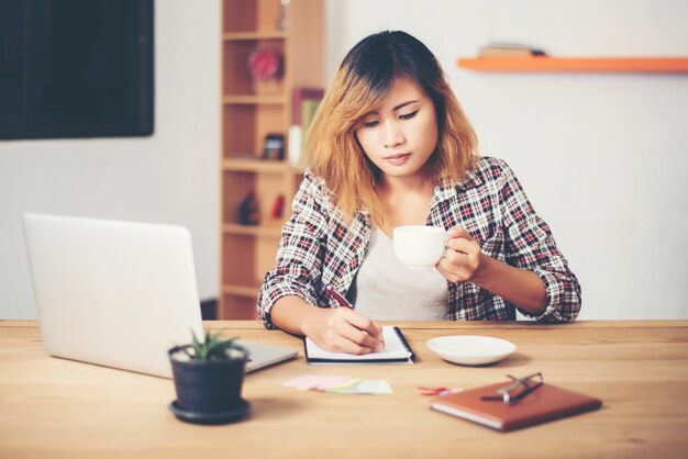 Woman having a coffee at work