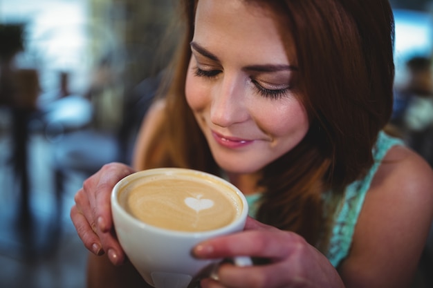 Woman having a cup of coffee in cafÃ©