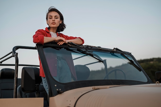 Free photo woman having fun traveling alone by car