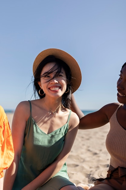 Woman having fun with friends by the sea