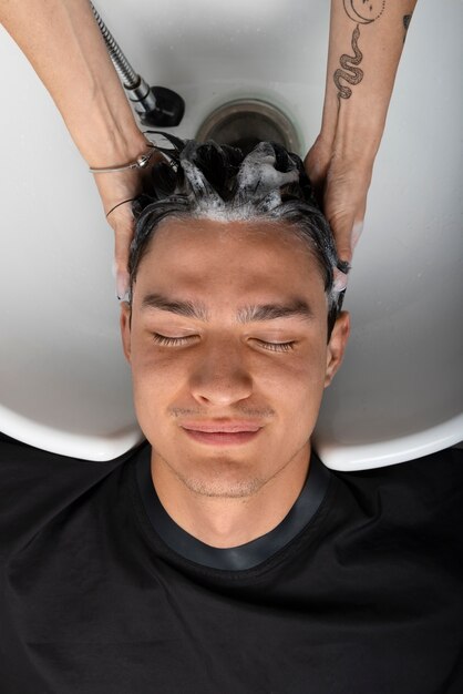 Woman having hair washed at latino hair salon