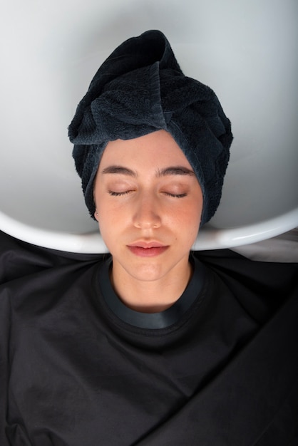 Woman having hair washed at latino hair salon