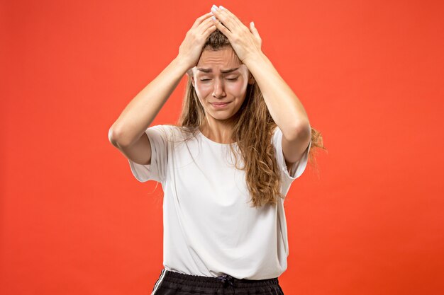 Woman having headache. Isolated over pastel .