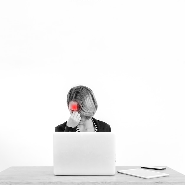 Free photo woman having headache while working on laptop