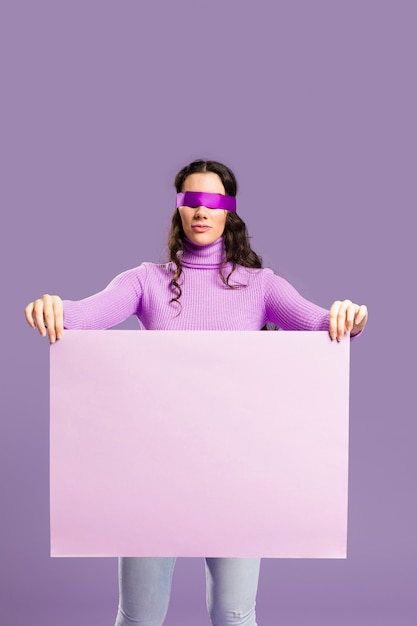 Free Photo woman having her eyes tied holding an empty cardboard