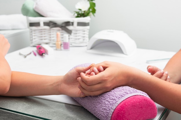 Woman having her manicure done at the salon with copy space