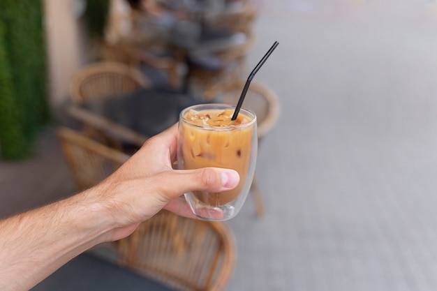 Woman having an iced coffee break outside